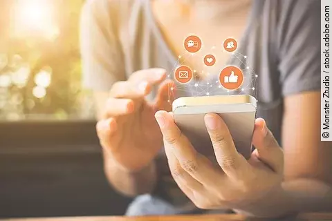 Woman hand using mobile smartphone with icon social media and so