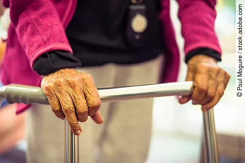 Old Indian Asian woman with a walking frame, UK