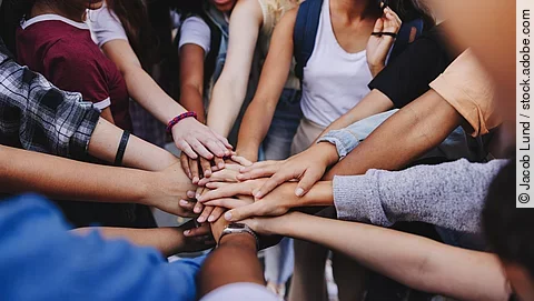 Multicultural teenagers expressing their unity and teamwork