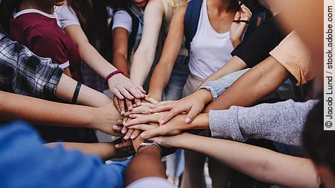 Multicultural teenagers expressing their unity and teamwork