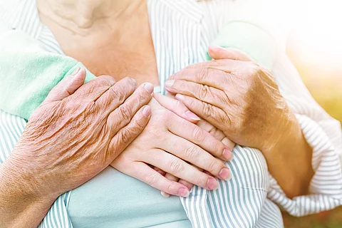 old and young hands hug, closeup