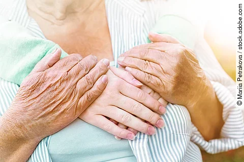 old and young hands hug, closeup