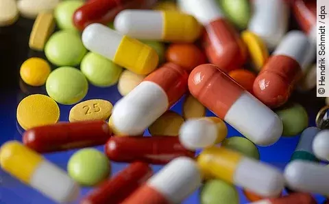 Verschiedene Tabletten, Kapseln und Dragees liegen auf einem Tisch