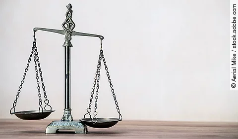 Law scales on wooden desk concept for justice and equality