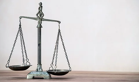 Law scales on wooden desk concept for justice and equality