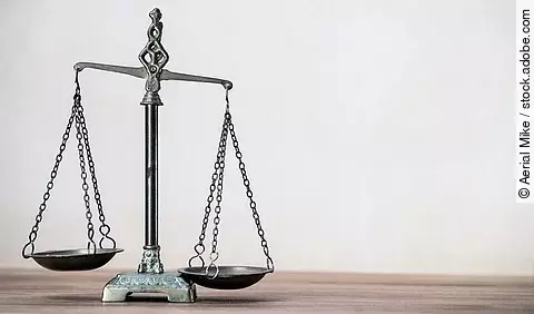 Law scales on wooden desk concept for justice and equality