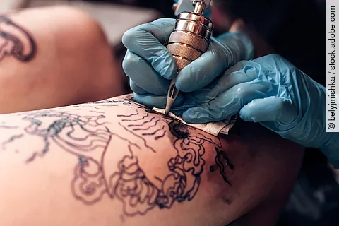 Closeup tattoo artist fill circuit tattooing