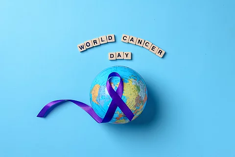 Globes with purple ribbon cancer awareness with word world cance