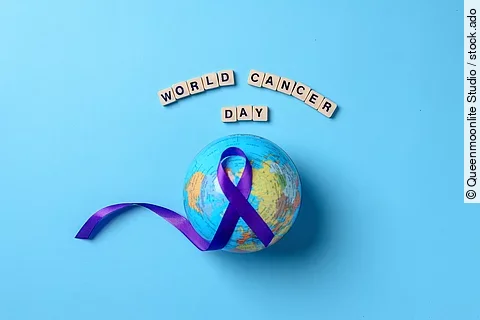 Globes with purple ribbon cancer awareness with word world cance