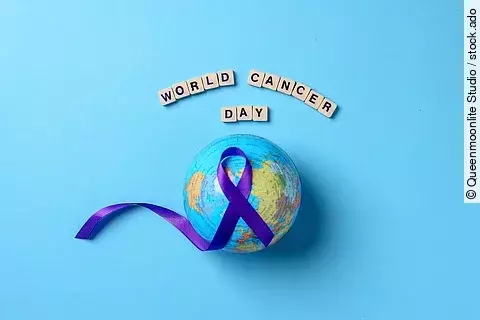 Globes with purple ribbon cancer awareness with word world cance