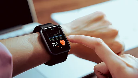 Close up of hand touching smartwatch with health app on the scre Close up of hand touching smartwatch with health app on the scre