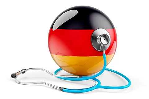 Kanzler Merz kündigt Tempo bei Gesundheits- und Pflegereform an Deutsch flag with stethoscope. Health care in Germany concept, 3D rendering