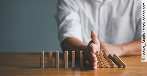 Risk and Strategy in Business, Hand stopping wooden block domino
