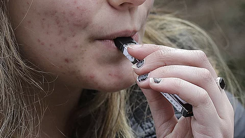 Nahaufnahme einer Hand, die eine E-Zigarette hält