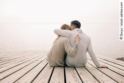 couple hugging on a pier