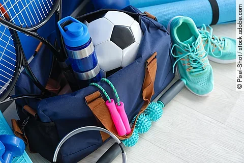 Set of sport equipment on floor near color wall