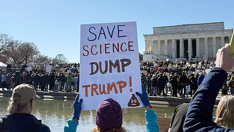Menschen mit Plakaten stehen vor dem US-Kapitol und demonstrieren für Wissenschaftsfreiheit und den Erhalt von Forschungsgeldern.