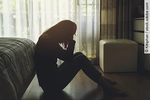 Lonely young woman feeling depressed and stressed sitting head in hands in the dark bedroom, Negative emotion and mental health concept